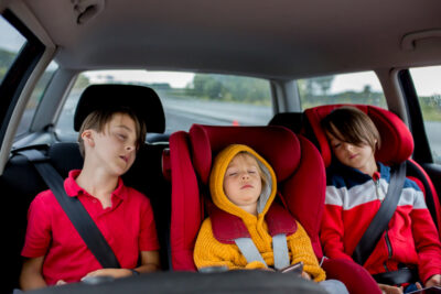 Three boys in car in carseats of locked car.